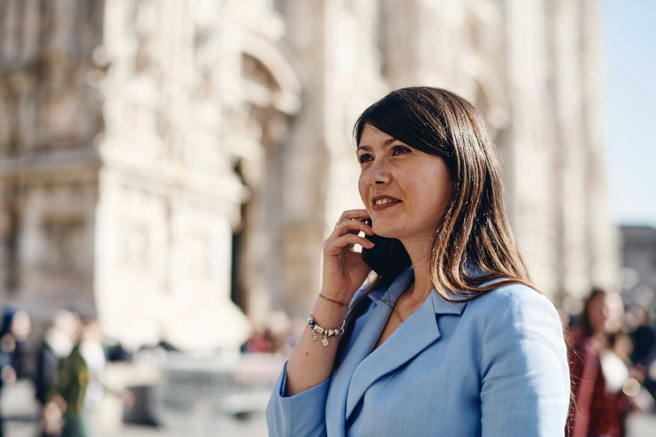 Woman in a suit on a mobile phone while outside